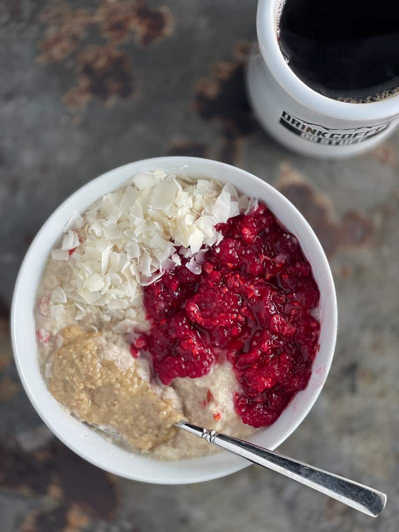 5 minute quinoa flakes topped with smashed raspberries walnut butter and unsweetened coconut