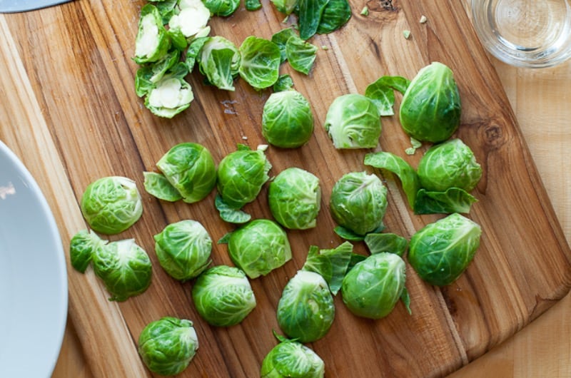 Brussels sprouts sliced on a cutting board