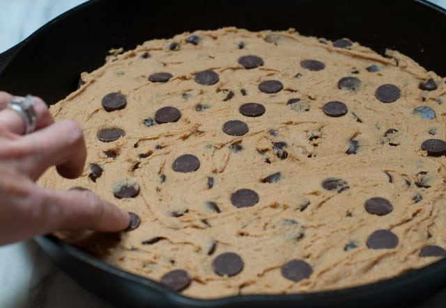 Adding extra chocolate chips to the skillet