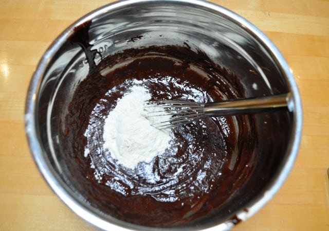 adding flour to chocolate mixture
