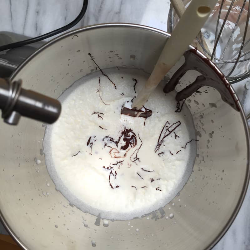 adding metlted chocolate to heavy whipping cream