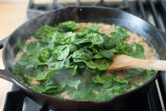 Adding the spinach to the pan