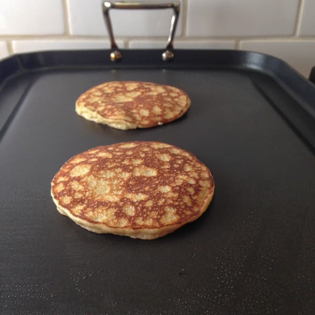 Browned almond flour pancakes on the griddle