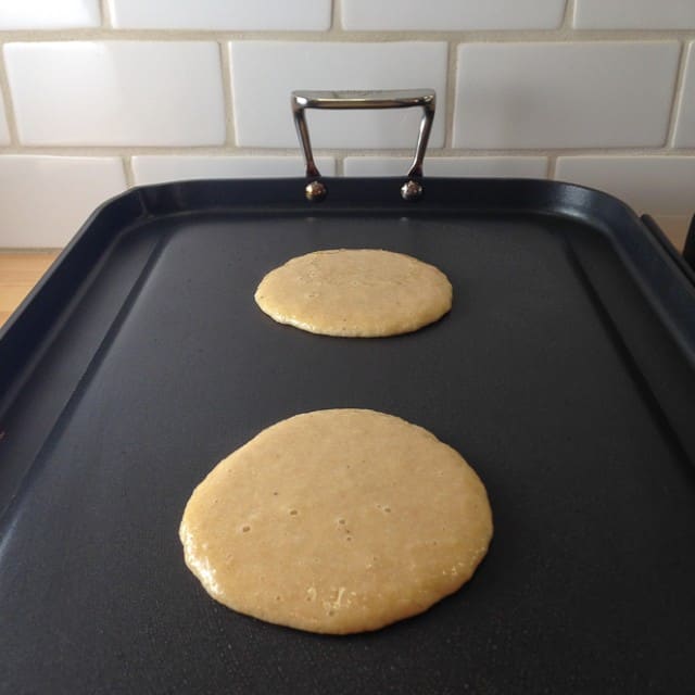 Almond four pancakes on the griddle