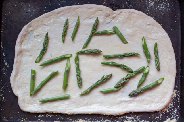 Asparagus on the prepared pizza dough
