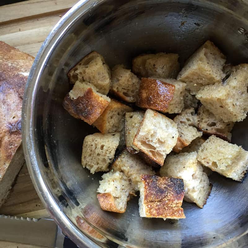 Bread cubes tossed with olive oil salt and pepper