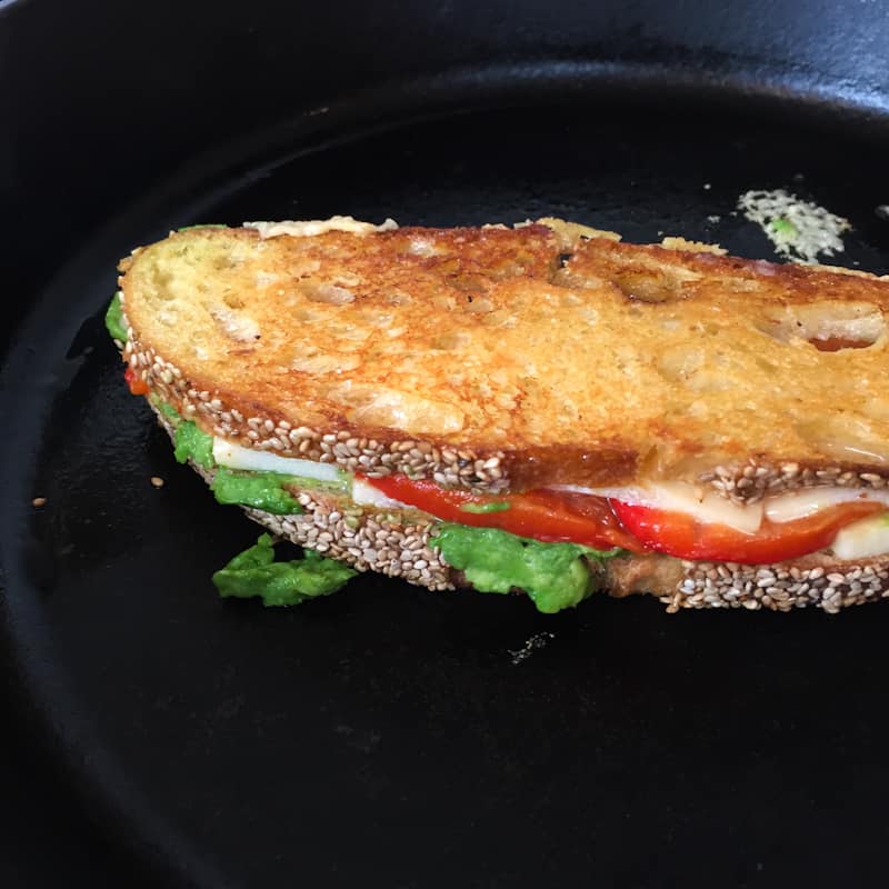 browned grilled cheese in a cast iron skillet
