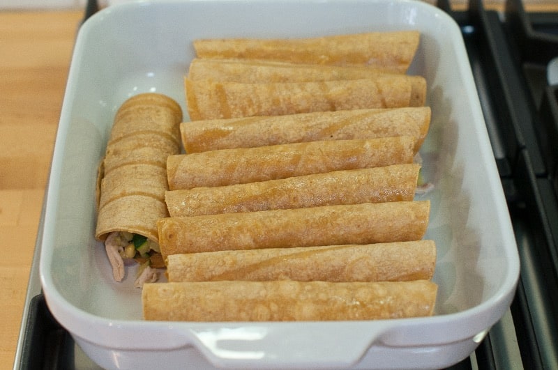 chicken enchiladas rolled in baking dish