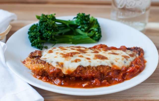 Chicken parmesan on plate with broccoli