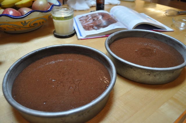 Chocolate cake batter in prepared cake pans
