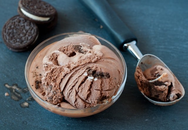 chocolate Oreo ice cream in a bowl with an ice cream scooper