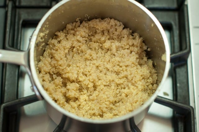 Cooked quinoa in a pot on the stove.