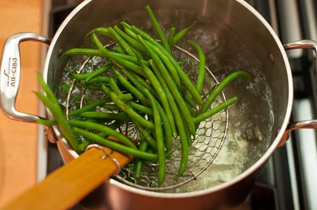 Removing green beans from pot