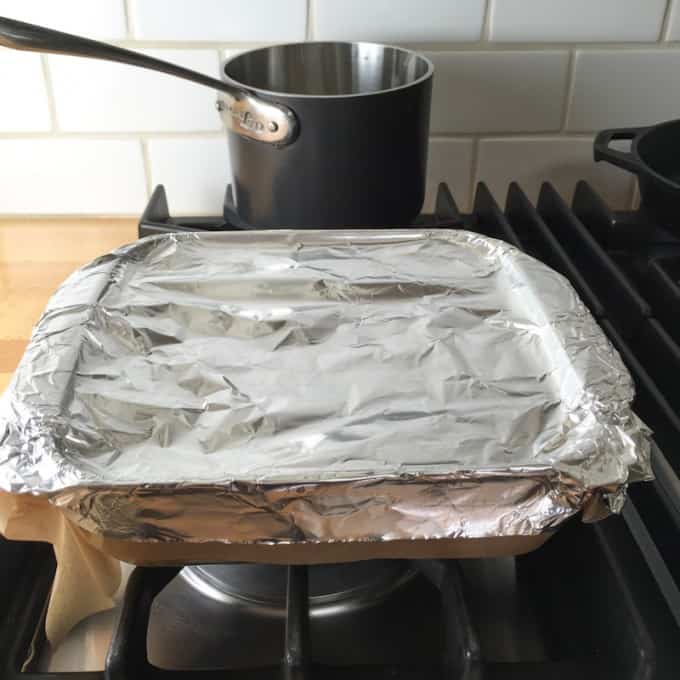 Cover the rice with parchment and foil