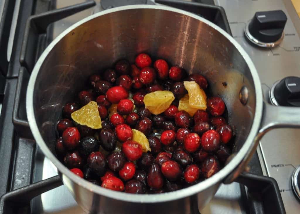 Cranberries and oranges in pot