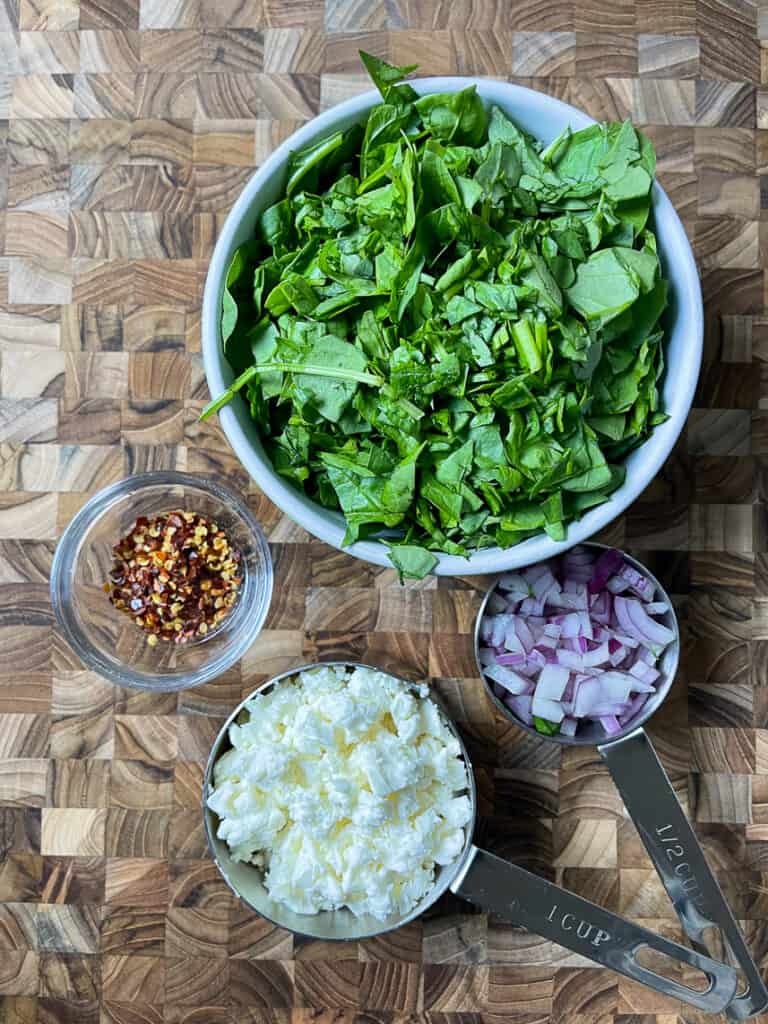 Diced red onion, crumbled feta and chopped spinach.
