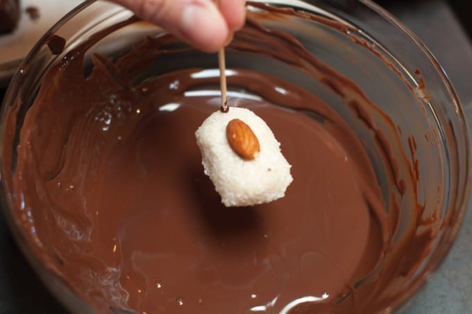 Dipping the almond joy into the chocolate