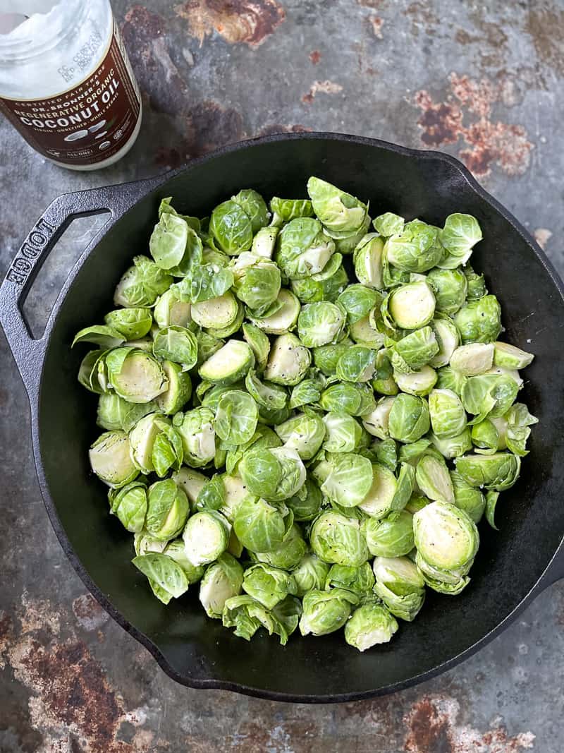 Raw brussels sprouts in a skillet on the counter
