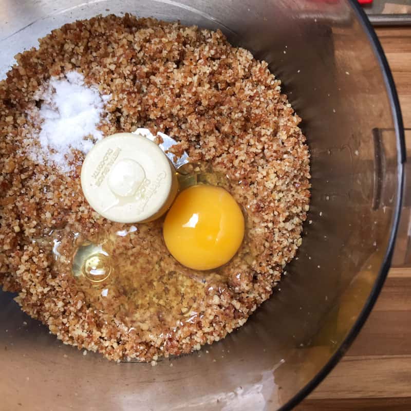 Egg salt baking soda and vanilla added to the processed dates and walnuts