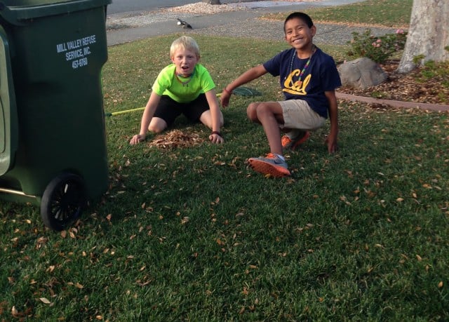Eli and friend doing yard work to earn money