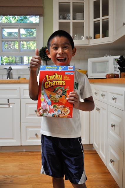 Eli holding box of Lucky Charms