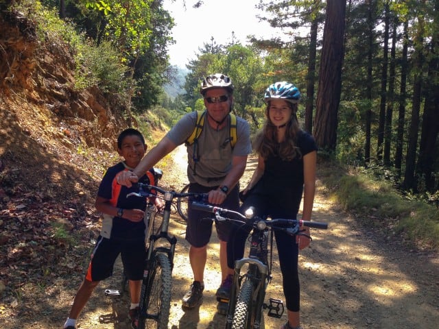 Eli, John and Zoe biking up mountain