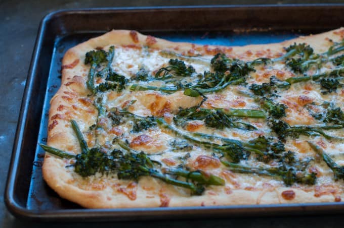Finished Broccoli rabe pizza on a baking sheet