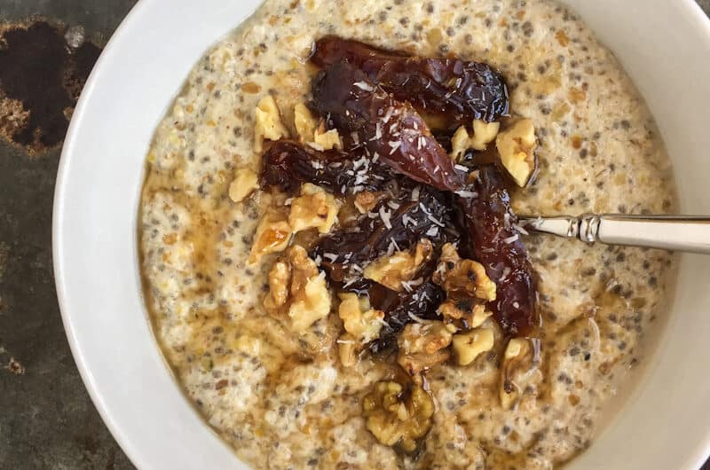 Grain free paleo vegan breakfast porridge in a bowl with fruit
