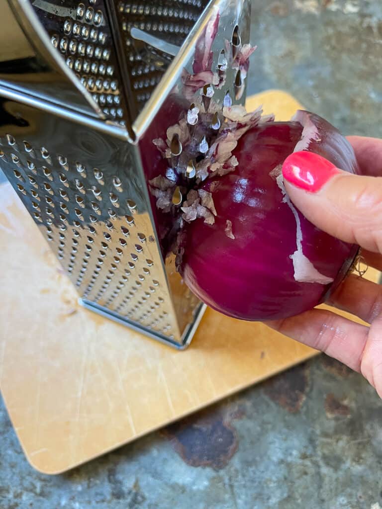 Grating an onion on a grater.