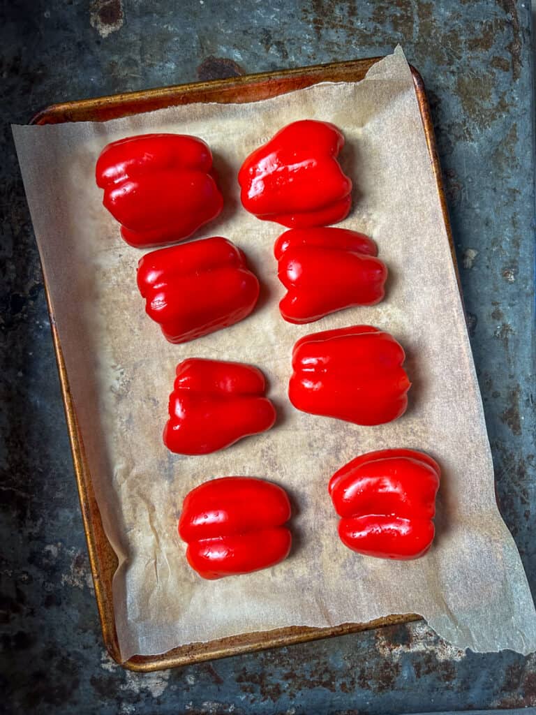Halved peppers on baking sheet.
