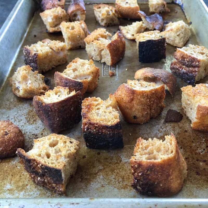 Homemade croutons on a baking pan