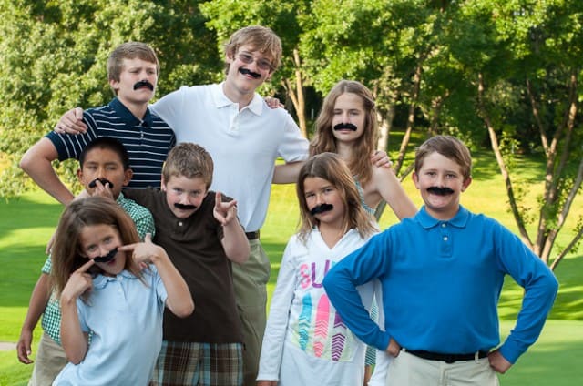 Kids wearing fake mustaches