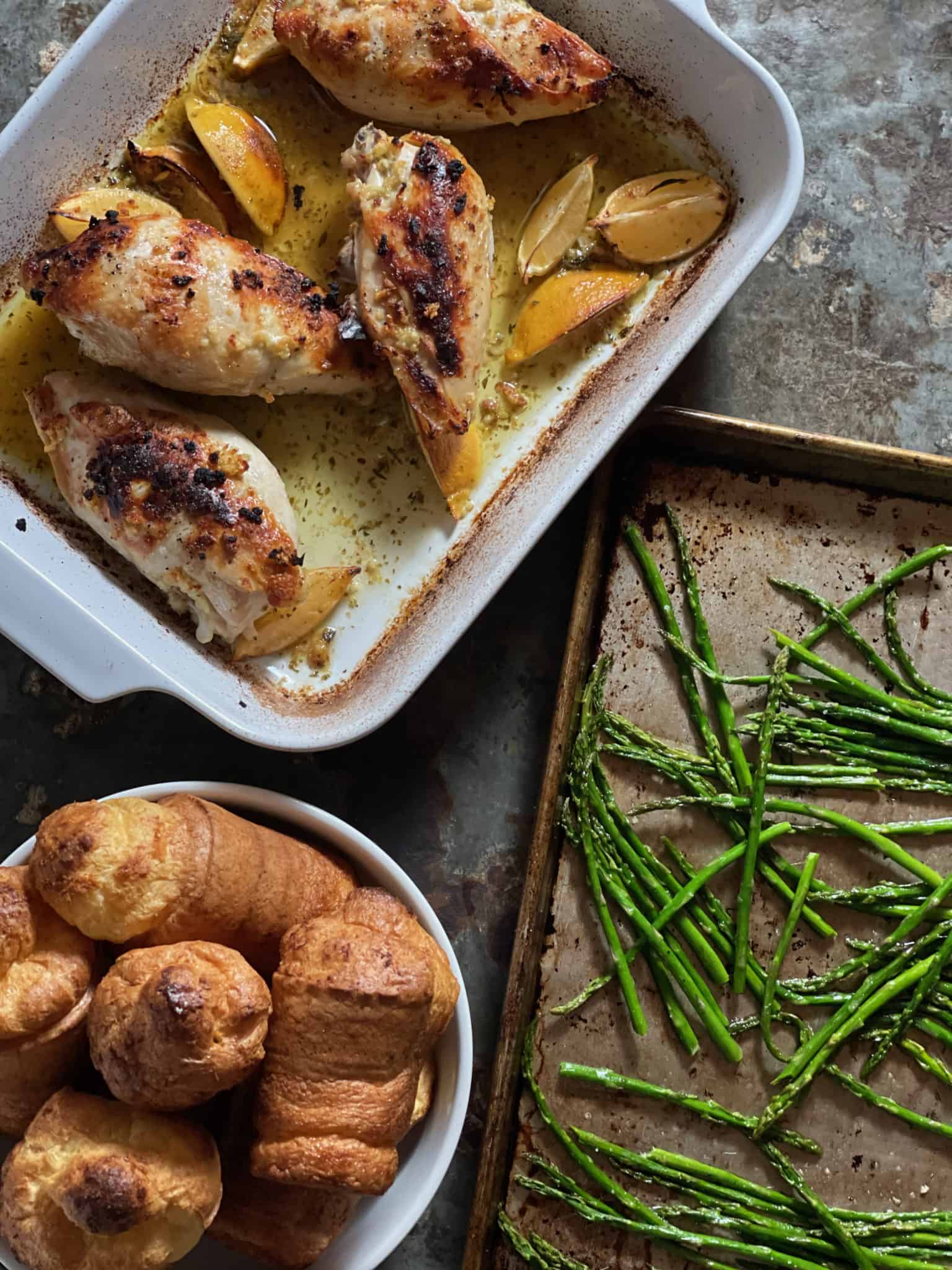 Chicken, Asparagus and rolls on table