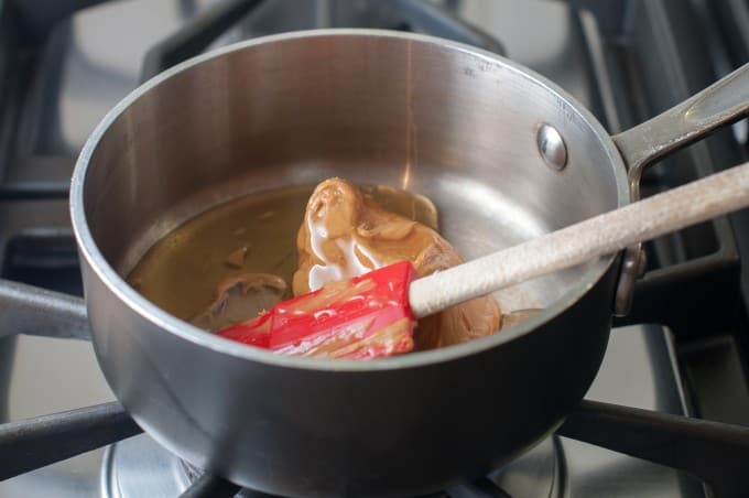 Melting the peanut butter and honey in a saucepan