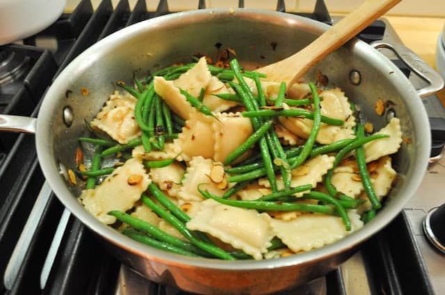 Add ravioli and green beans to pan