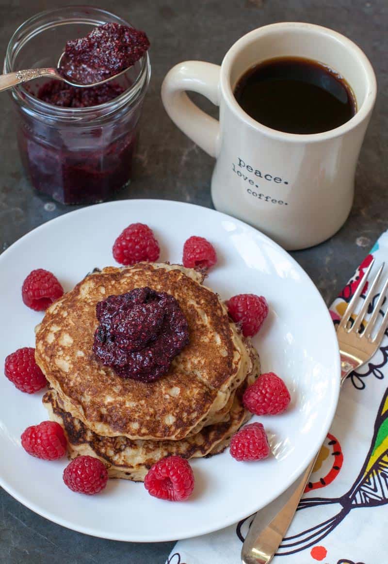 Oatmeal pancakes on a plate with fruit and coffee