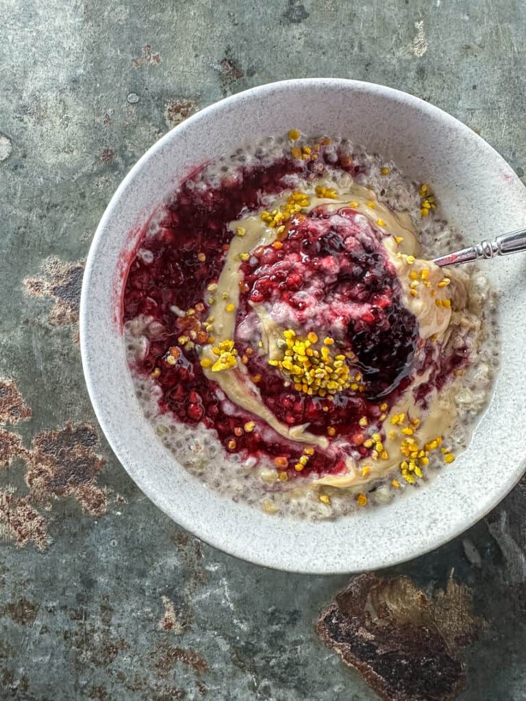 Overnight buckwheat porridge with tahini, blackberry chia compote and bee pollen.