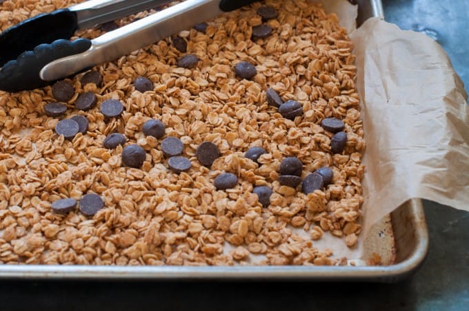 Peanut butter chocolate chip granola on the baking sheet