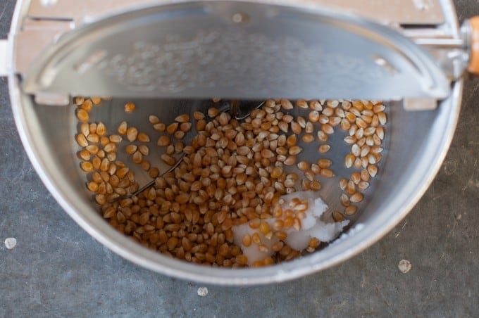 Popcorn kernels and coconut oil in popcorn maker