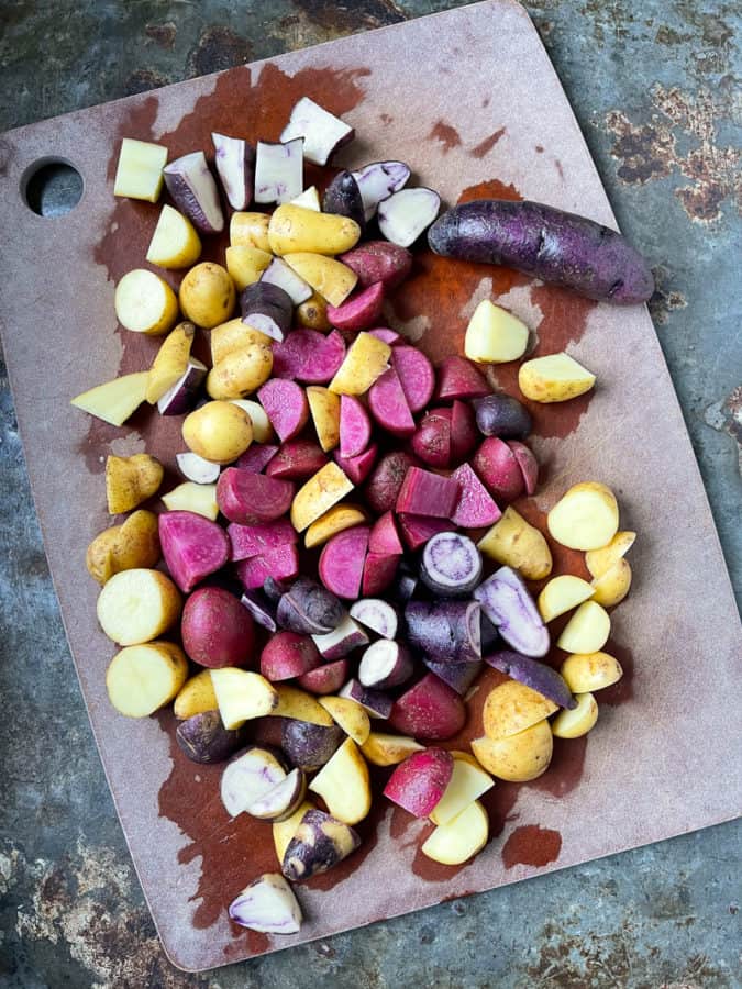 Potatoes cut to size on cutting board