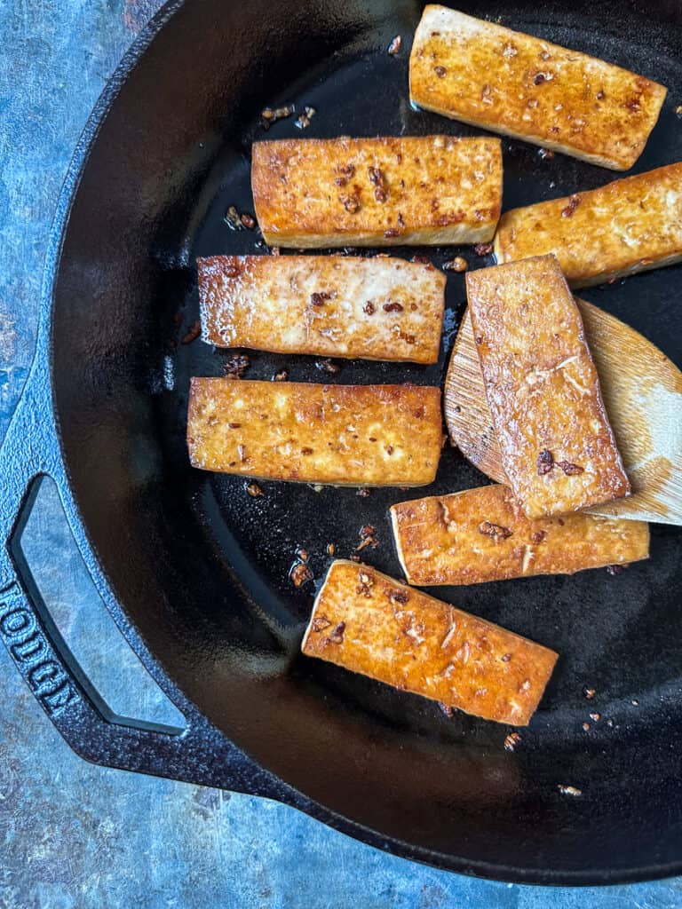 Quick and easy sautéed tofu in cast iron skillet.