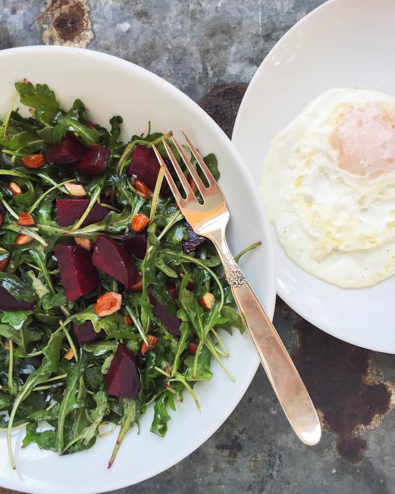 roasted beet and arugula salad with toasted almonds fried egg