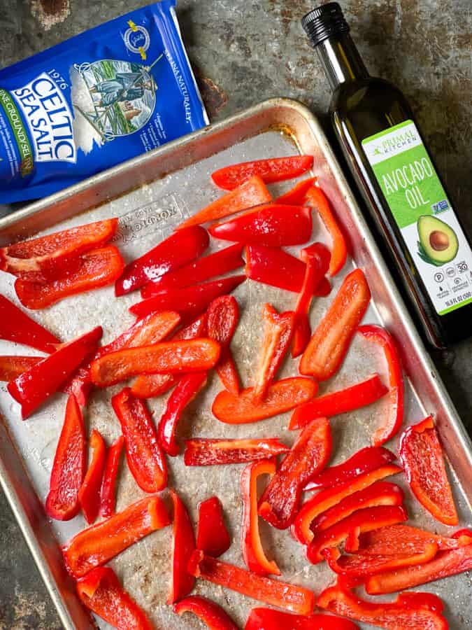Roasted red peppers on sheet pan, celtic sea salt and olive oil