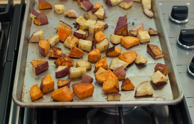 Roasted sweet potatoes on a baking pan.