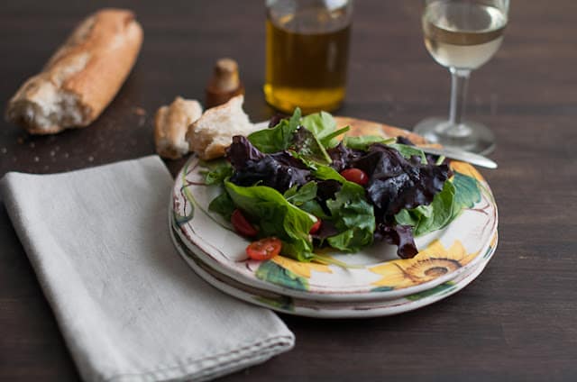 Salad on plate with rustic bread
