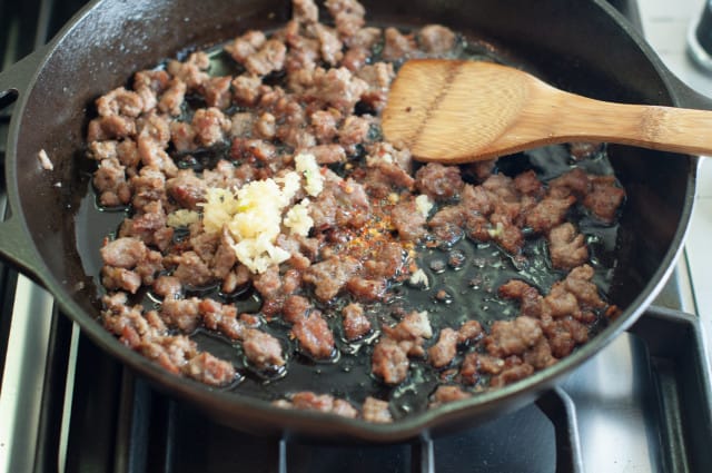 Add garlic to browned sausage