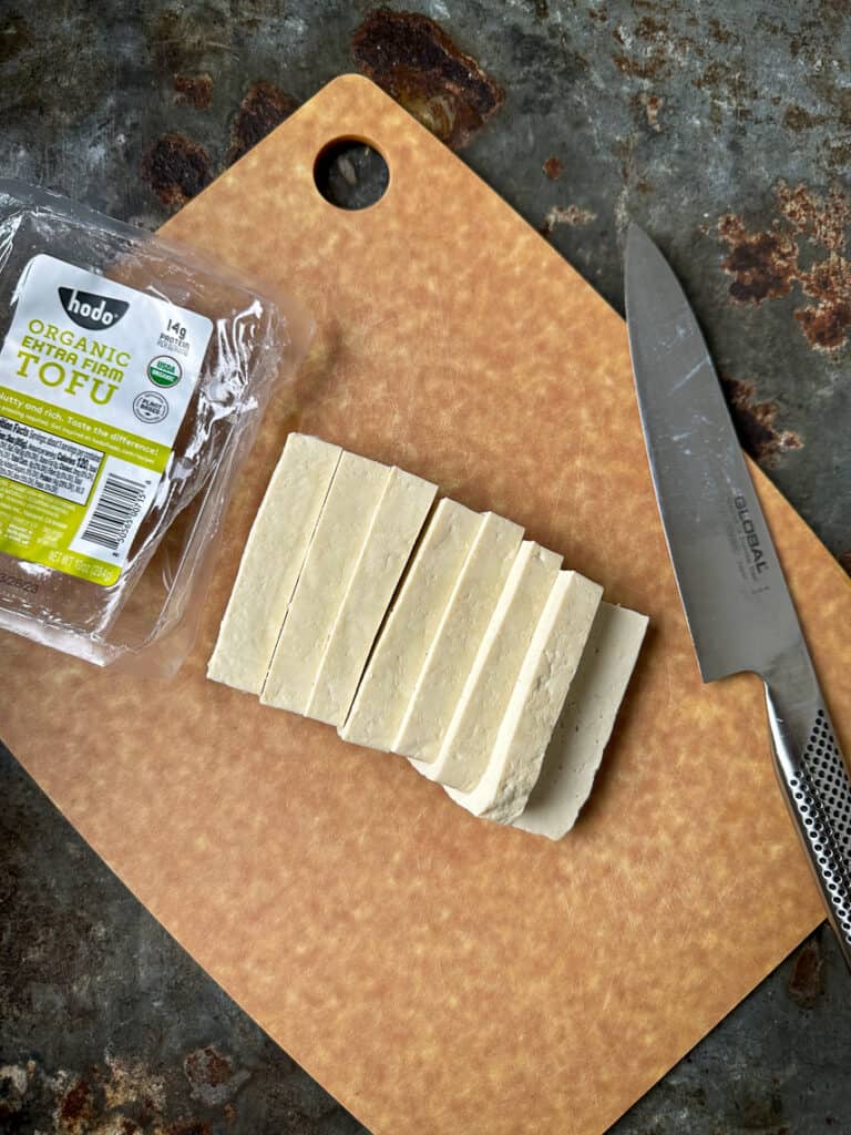 Sliced tofu on cutting board. 