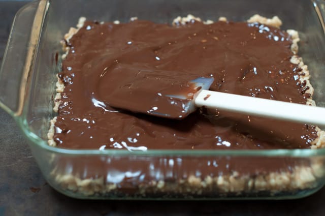 Smoothing the chocolate over rice crispy bars