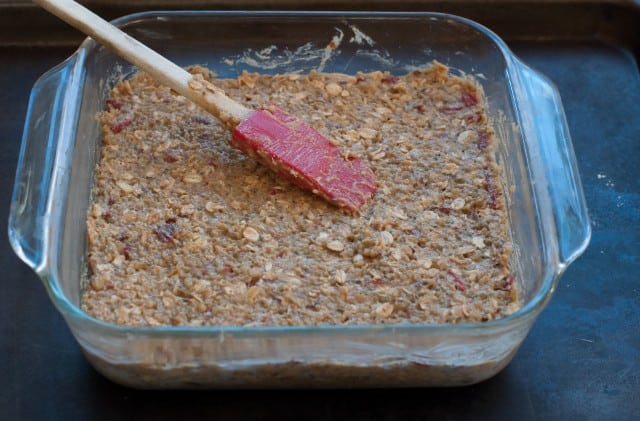 Spreading the quinoa bar mixture into a pan.