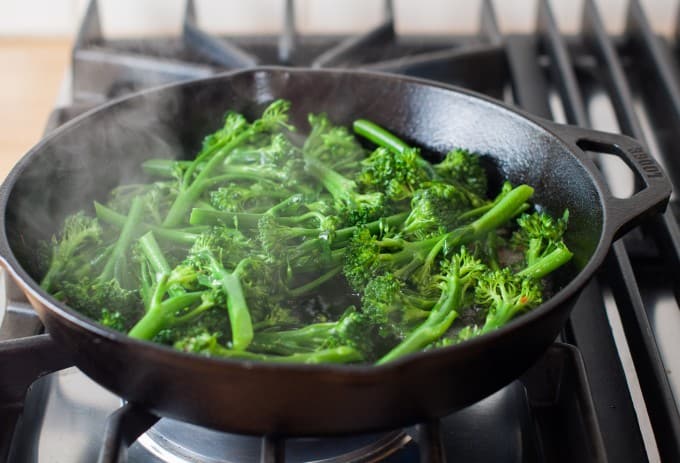 Steamed broccoli in a skillet on the stove